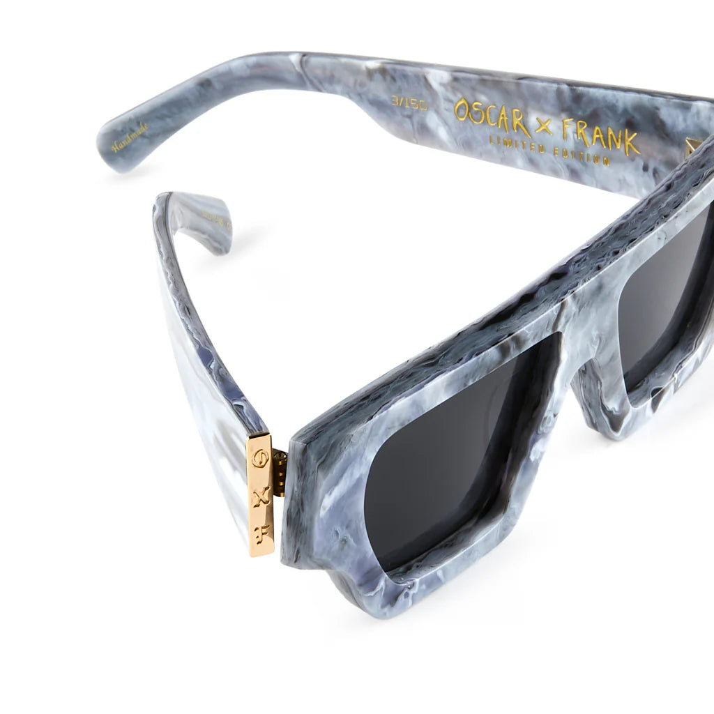 Sunglasses with gray marbled frame and black lenses on a white background