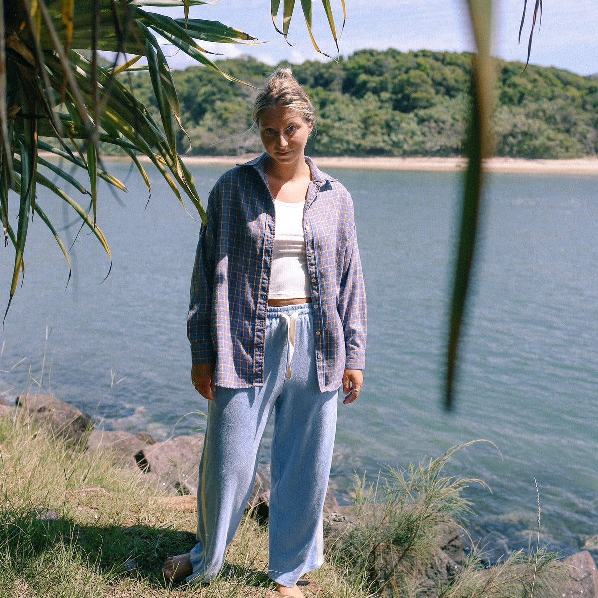 Model wearing 100% cotton terry towelling pants in light blue with white stripe by Atmosea