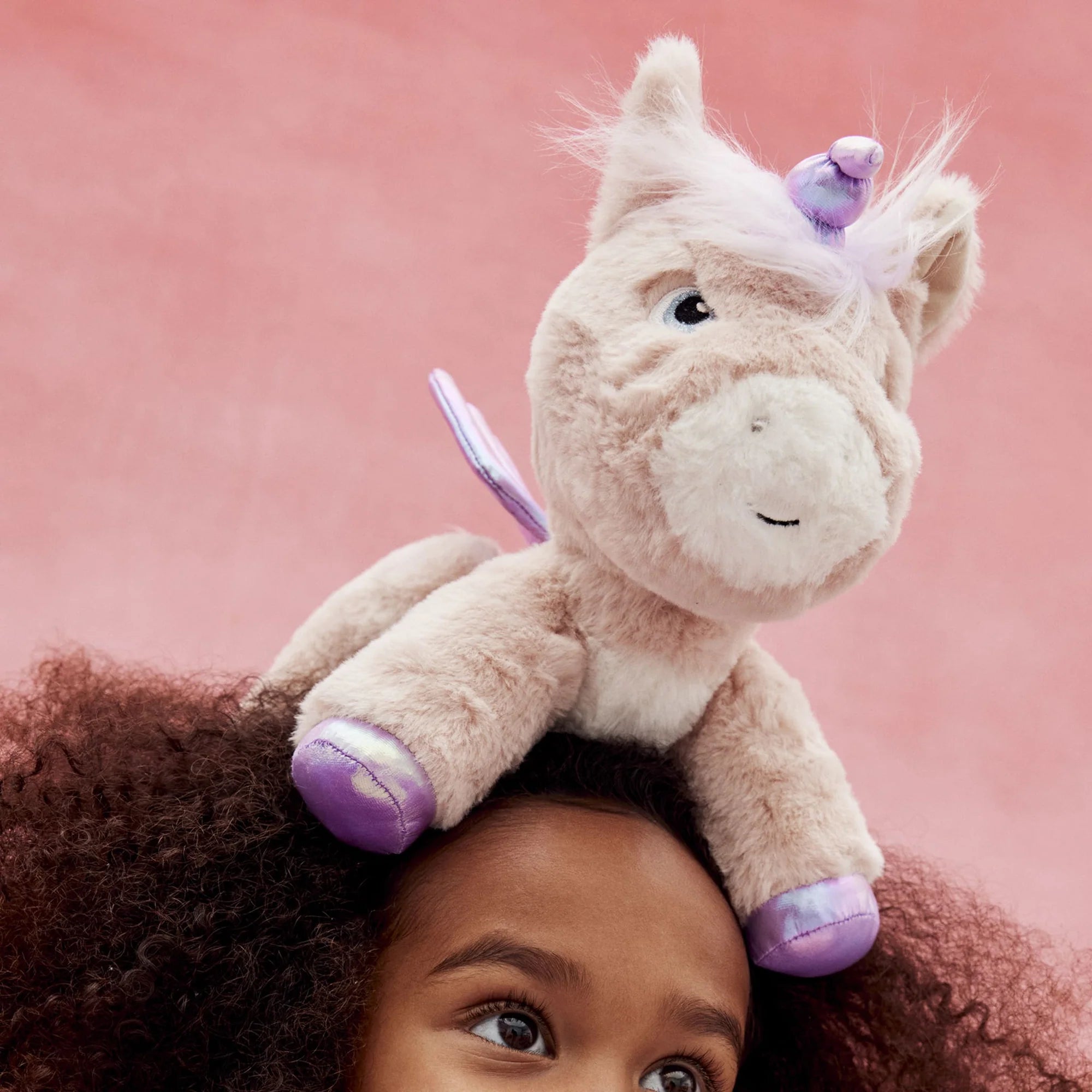 Girl playing with soft toy - Dinkum unicorn Shimmer by Olli Ella Plush toy