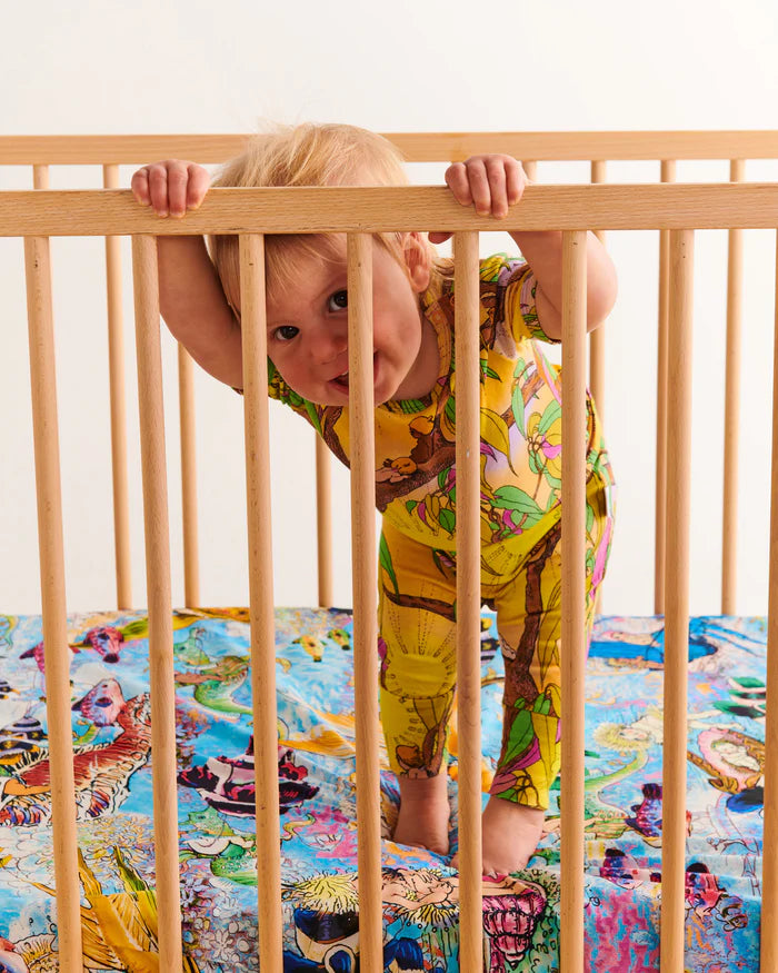 Little boy in a short sleeve zip romper by Kip and Co