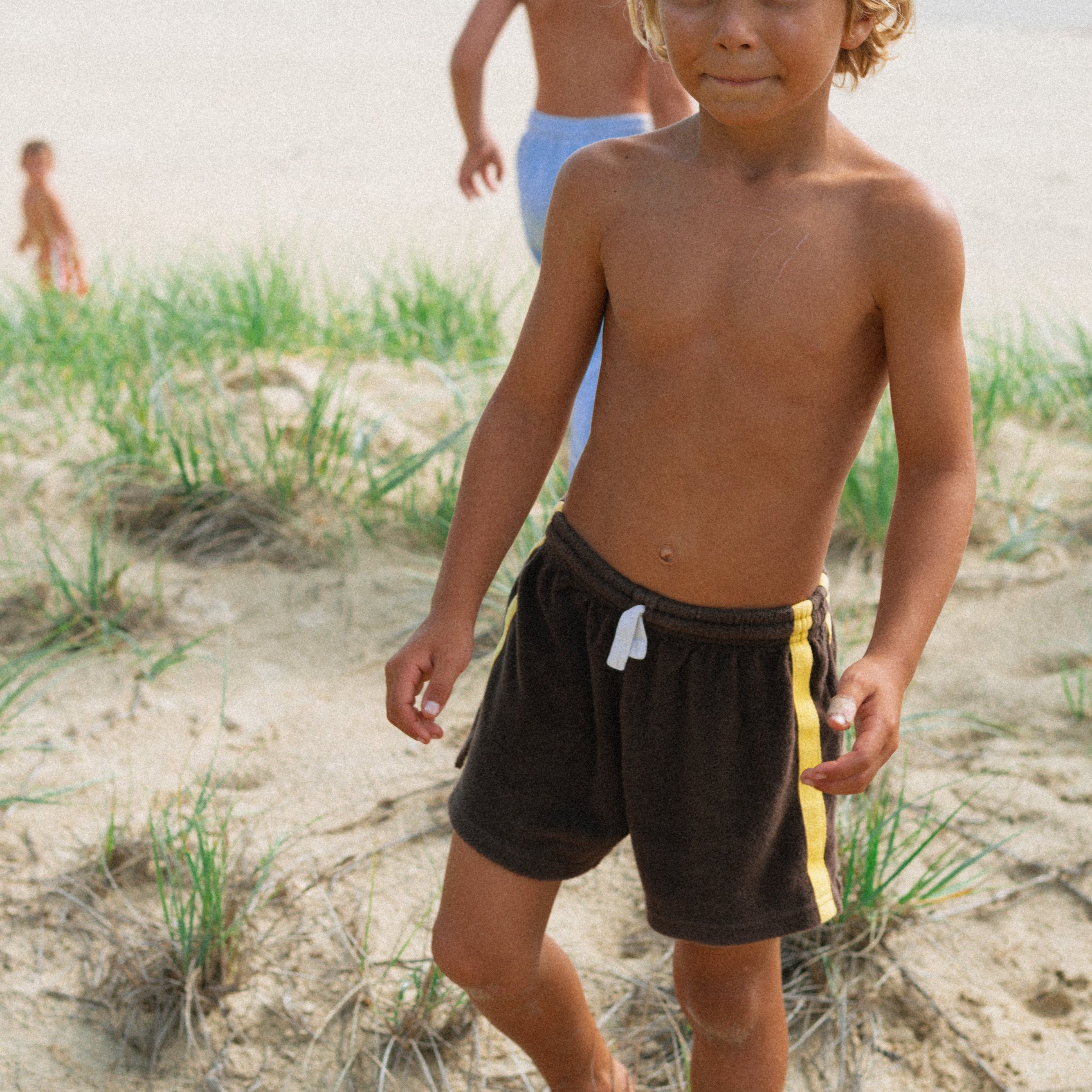 Boy wearing brown terry shorts by Atmosea