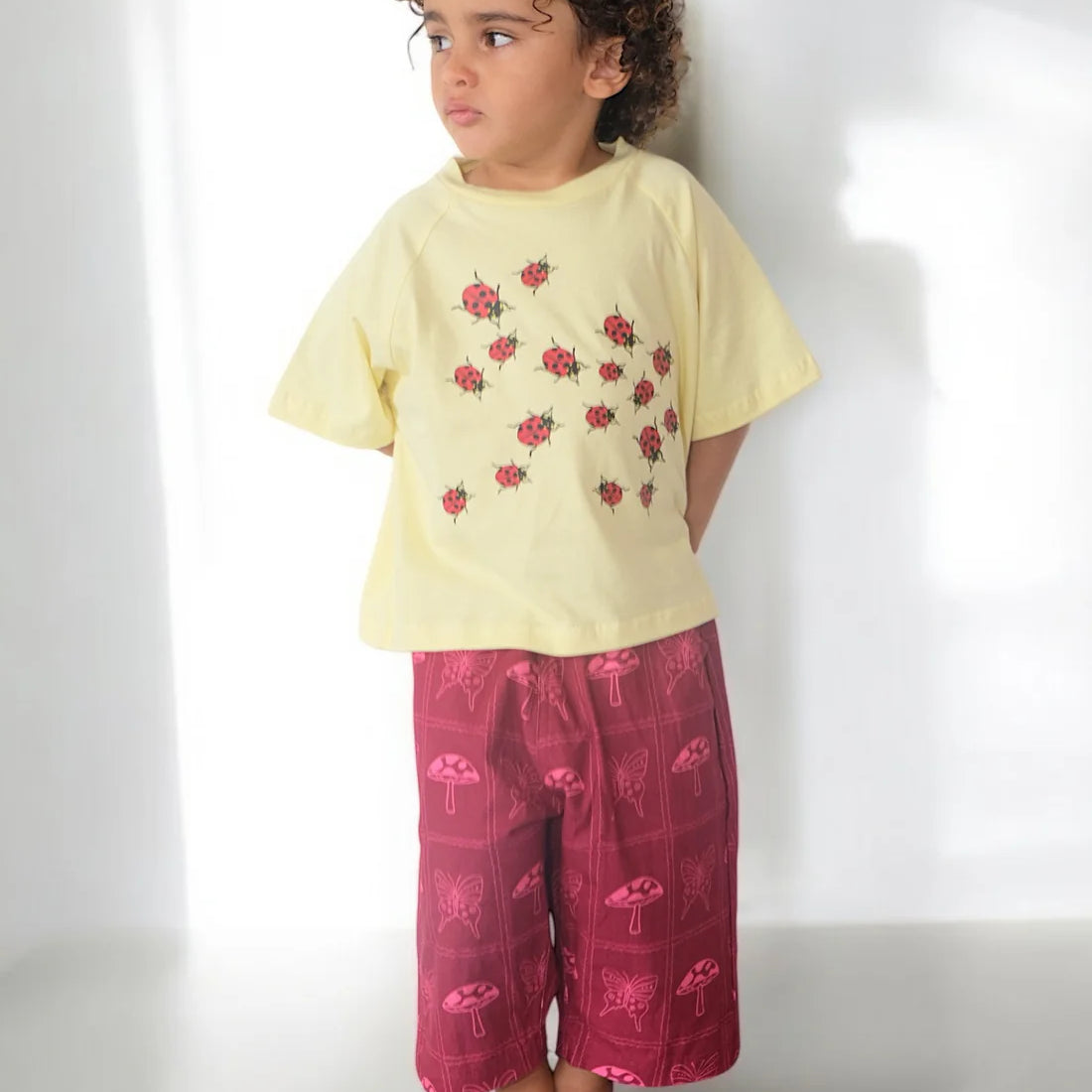 girls canvas pants in red pink cerise with mushroom and butterfly print