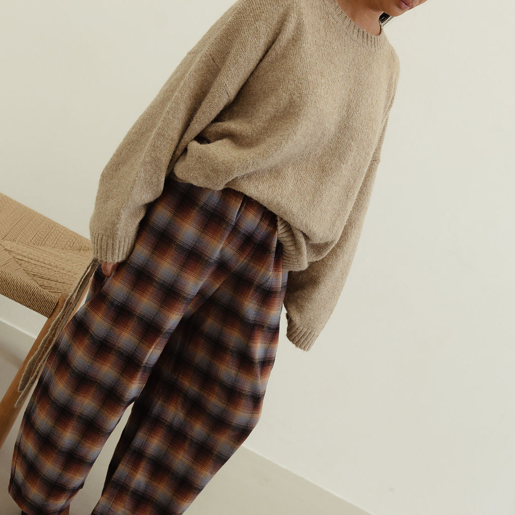 Front angled view showing Vali check pants brown blue plaid design with loose comfortable fit