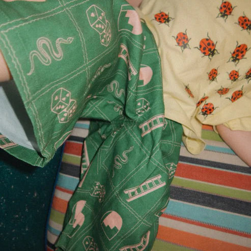 Child wearing the green snakes and ladder pants by Sauce Mini