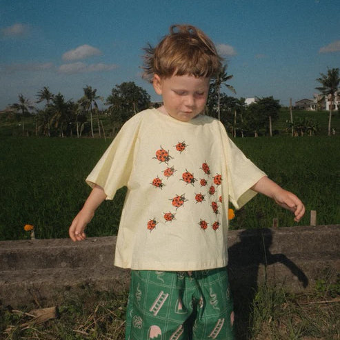 Child wearing the green snakes and ladder pants by Sauce Mini