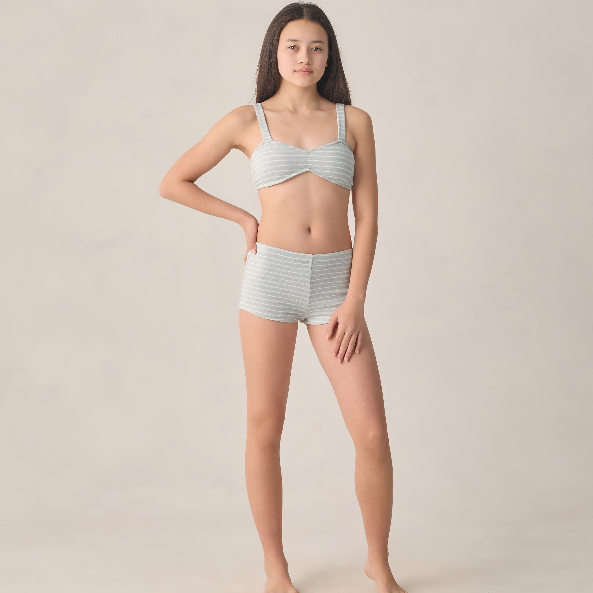 teen girl wearing boyleg bikini with blue and white stripes