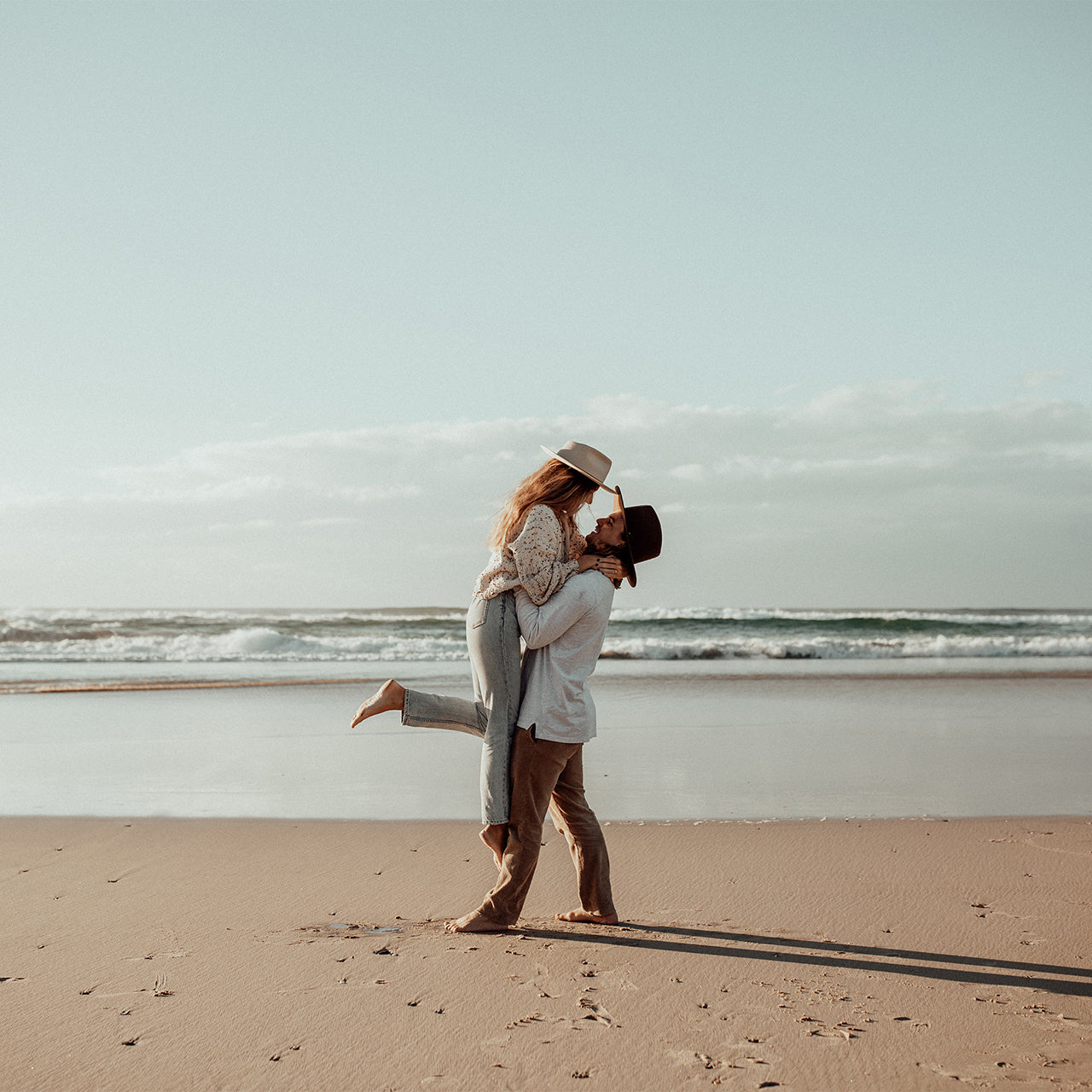 A couple at the beach wearing Calloway hats by Will and Bear