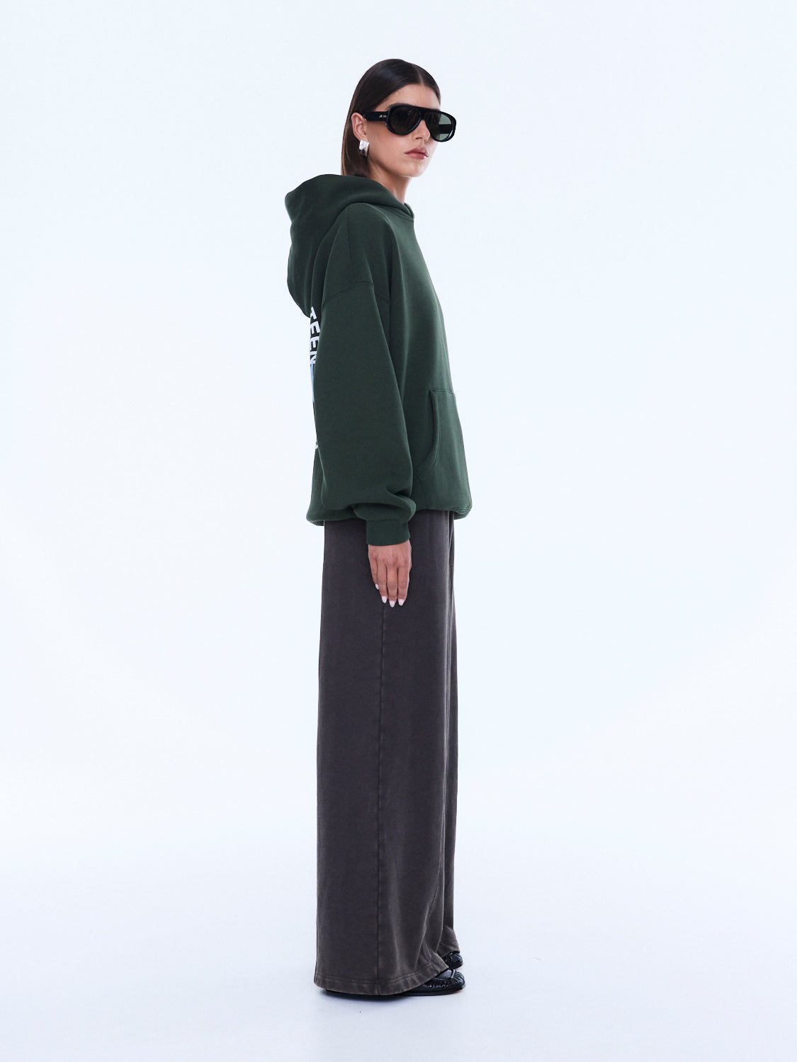 Side profile of moss green Aries Hoodie with oversized fit and hood