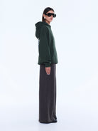 Side profile of moss green Aries Hoodie with oversized fit and hood