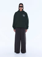 Full body front view of moss green Aries Hoodie with chest logo