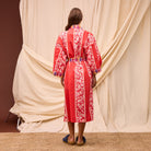 Back view of red cotton robe displaying full-length kimono style and plaid belt