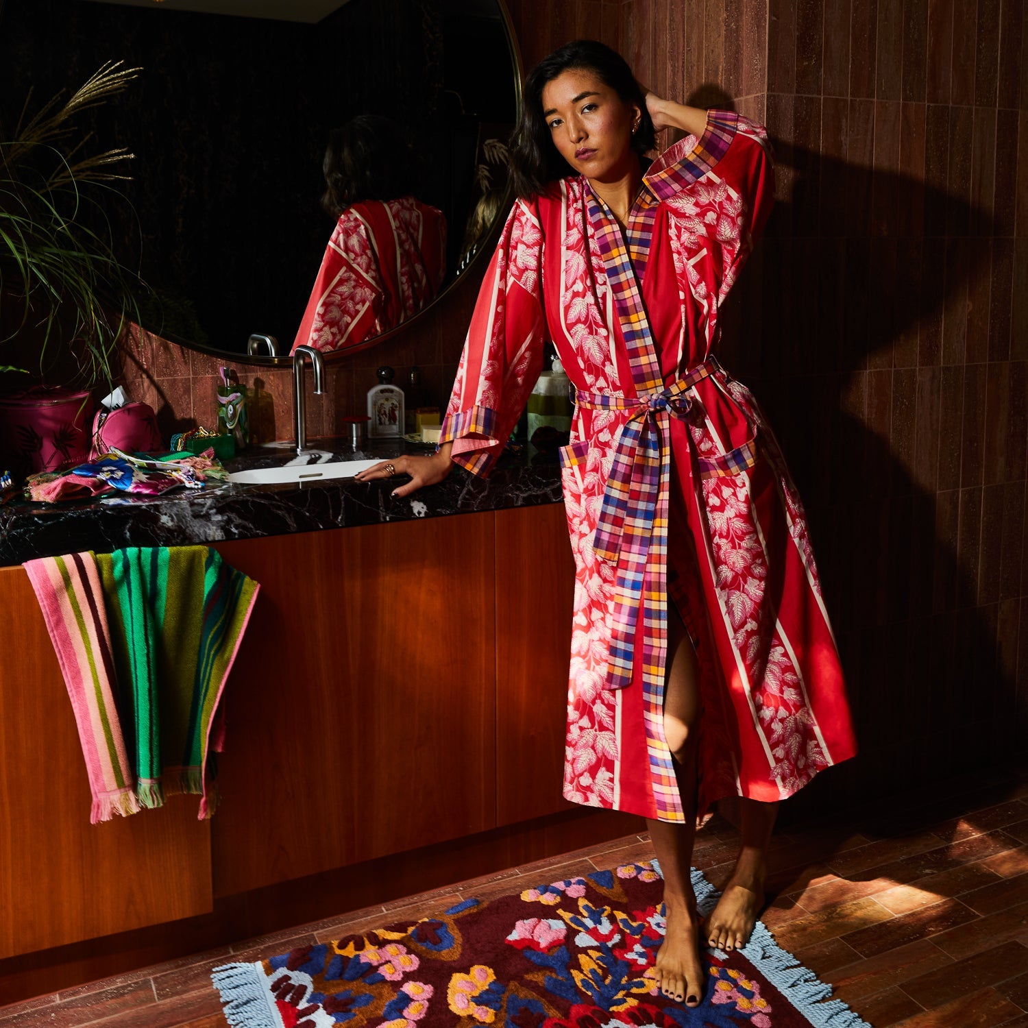 Side angle of cotton robe with palm print and plaid accents in modern bathroom