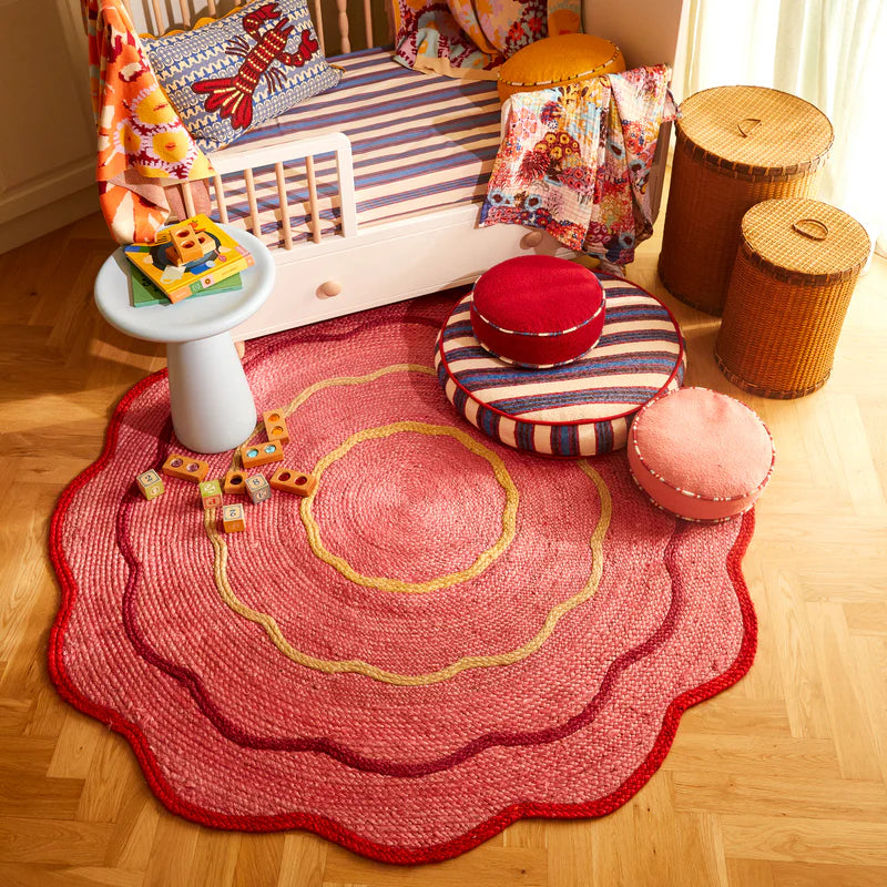 Pink jute rug with yellow and red flower like design