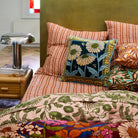 Aletha Velvet Cushion by Sage & Clare styled in bed