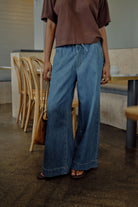 Side view of Andie Wide Leg Drawstring Pant in fresh indigo denim showing relaxed wide leg silhouette