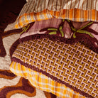 Aneta Tufted Blanket reverse side showing geometric maze pattern in burgundy and gold with fringe border