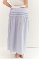 Back view of striped midi skirt showing smocked waistband and A-line shape