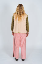 Back view of Atmosea blush pink panel pants showing wide leg fit and dark side stripe details