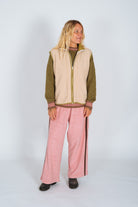 Front view full body shot of Atmosea blush Après Surf Panel Pant styled with olive and cream layers