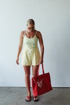 women wearing the light yellow bead singlet by By Billie