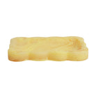 Aspen Gold yellow marbled resin small tray with scalloped wavy border, angled side view on white background