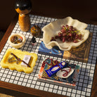 Aspen Gold marbled resin small tray with jewelry and matchbox, styled on a mosaic tile table with decorative objects