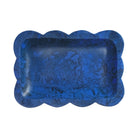 Overhead view of blue marbled resin small tray showing interior depth and scalloped rim