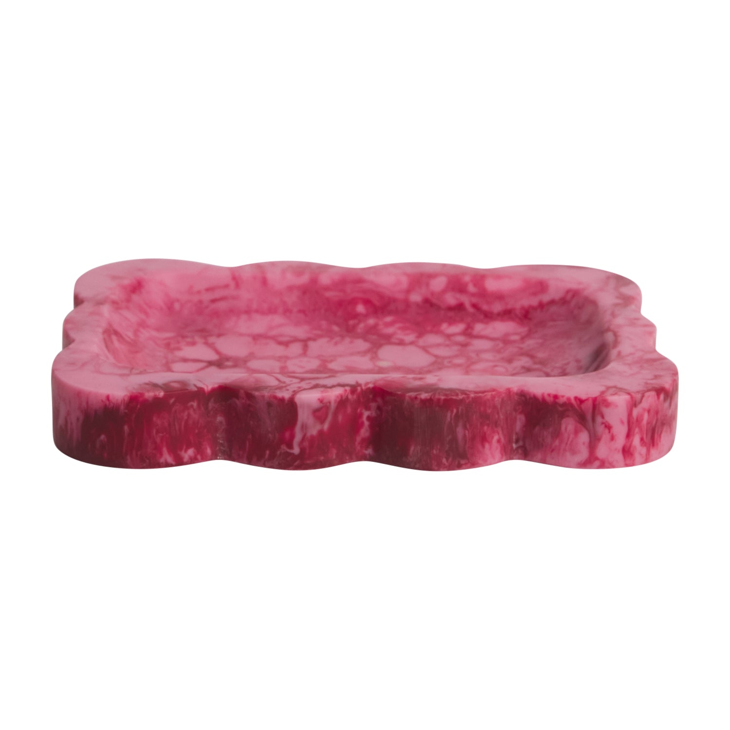 Crimson pink marbled resin small tray with scalloped wavy border, angled side view on white background