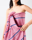 Model wearing Blushing Stripe bamboo terry bath sheet as strapless wrap showing full length and stripe detail