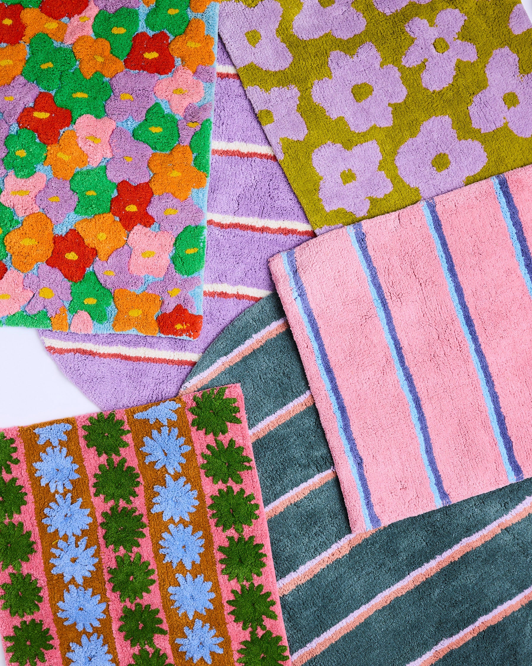 Collection of colorful Kip Co bath mats showing Blushing Stripe design with floral and geometric patterns