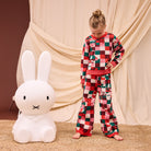 Full body view of child wearing Bodhi Kids knit pants in colorful checkered pattern with matching sweater