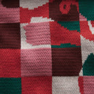 Macro close-up of knitted fabric pattern displaying colorful geometric squares on Bodhi Kids pants