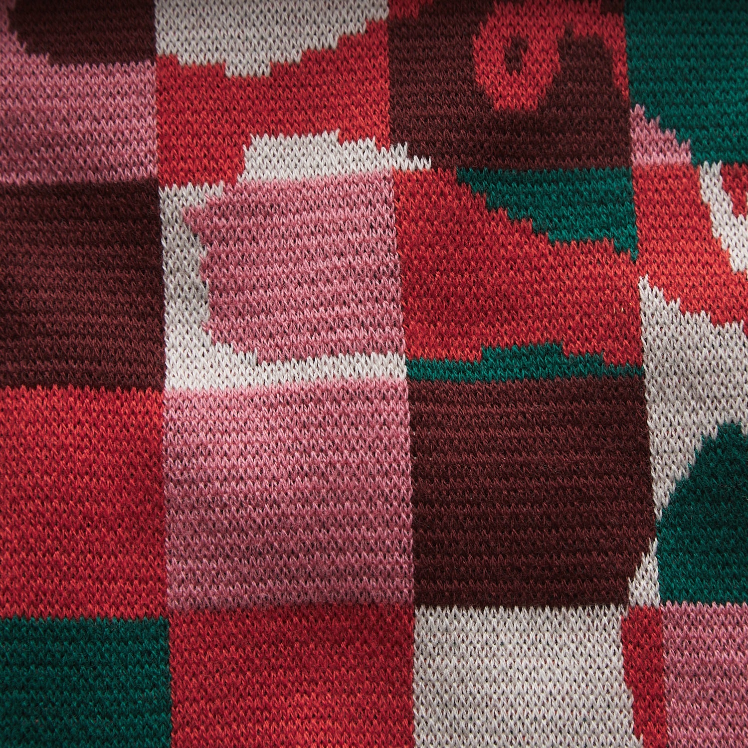 Detail view of Bodhi Kids knit fabric texture displaying red pink green white checkered pattern
