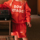 Golden Children red Bon Voyage sweatshirt and shorts set styled with vintage radio