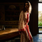 Bonny Cotton Robe in Poppy — three-quarter view showing open front with red border trim and floral check pattern