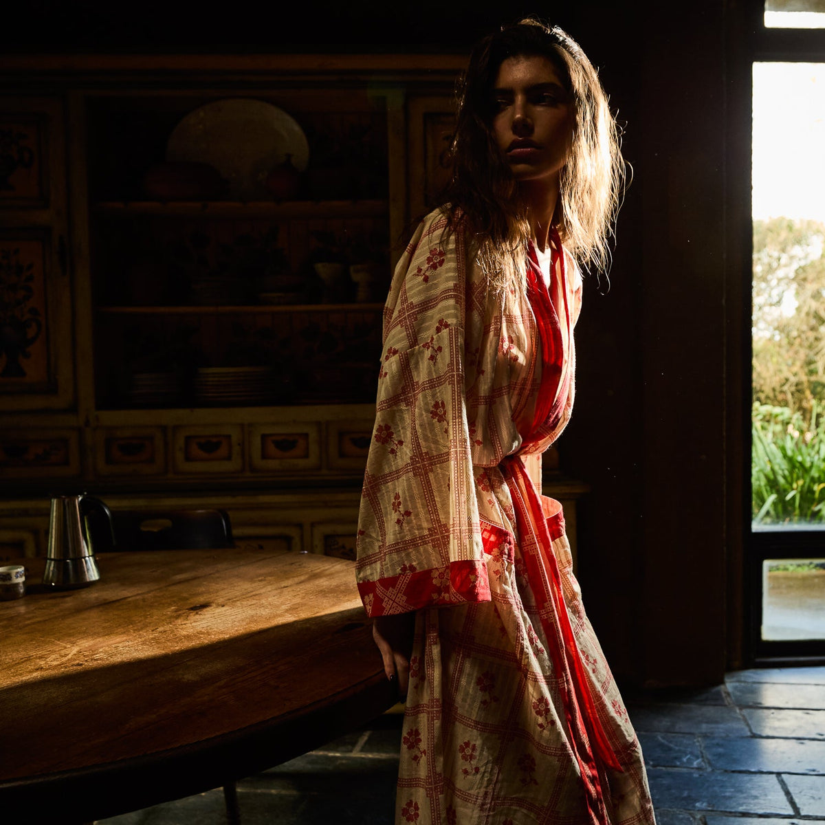 Bonny Cotton Robe in Poppy — three-quarter view showing open front with red border trim and floral check pattern
