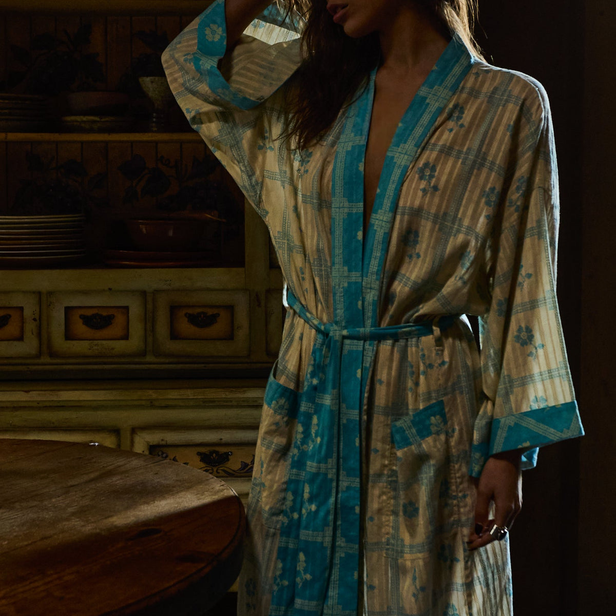 Bonny Cotton Robe in Turquoise — close-up front view showing turquoise border trim, belt, and floral check print