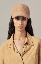 model wearing tan wool cap by Helen Kaminski