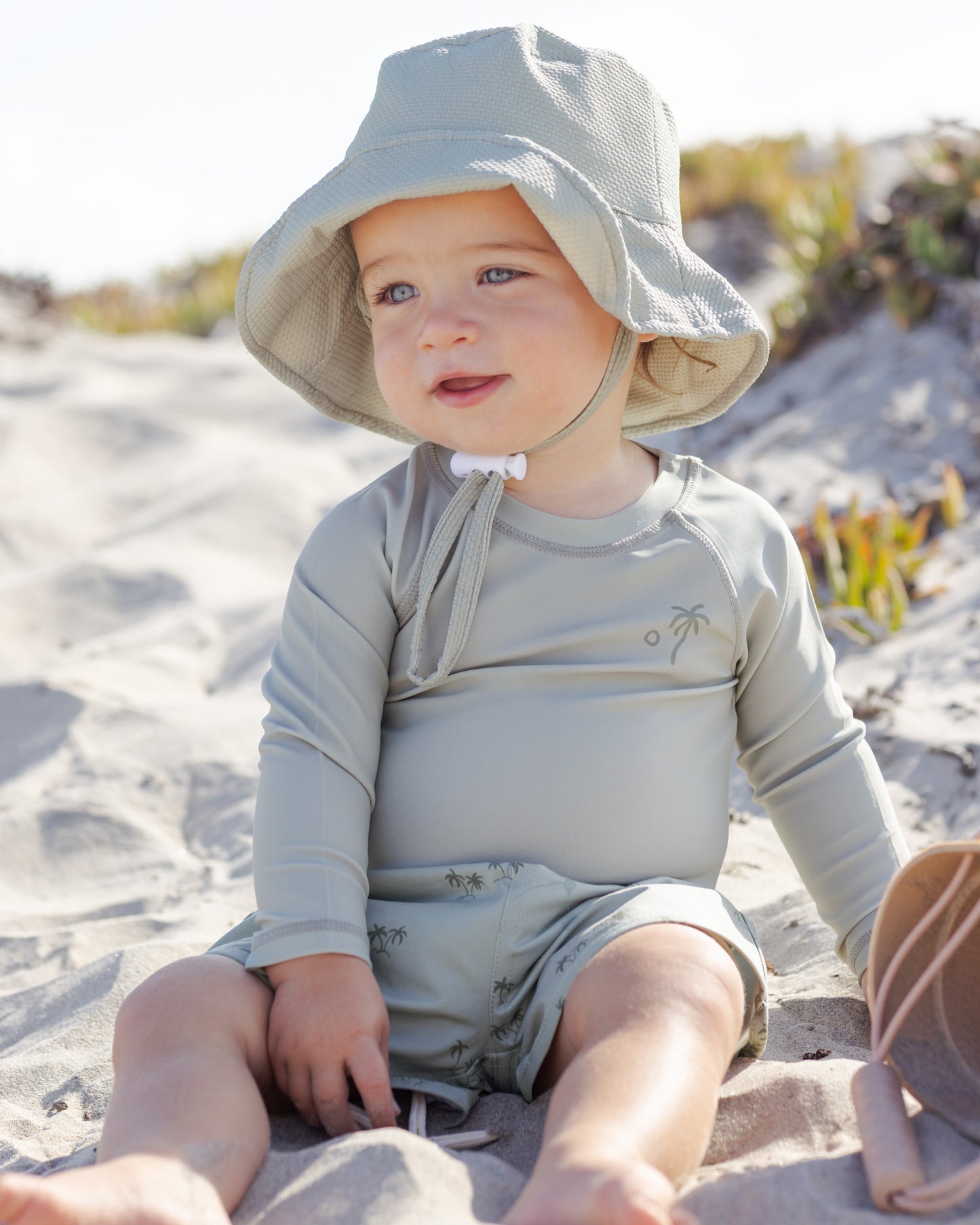 Front view of young boy wearing the Boys Swim Short Palm | Quincy Mae