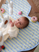 baby laying on Butter Blue Seersucker Playmat by Mosey Me