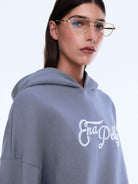 Close-up of Cassie Oversized Hoodie in gray showing white logo and hood detail
