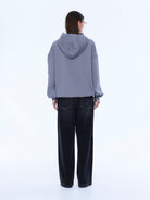 Back view of Cassie Oversized Hoodie displaying gray color and hood construction
