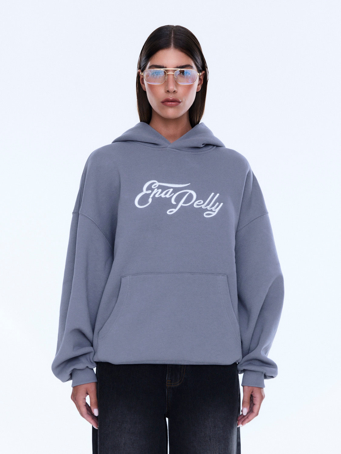 Front view of gray Cassie Oversized Hoodie with white logo and kangaroo pocket detail