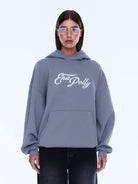 Front view of gray Cassie Oversized Hoodie with white logo and kangaroo pocket detail
