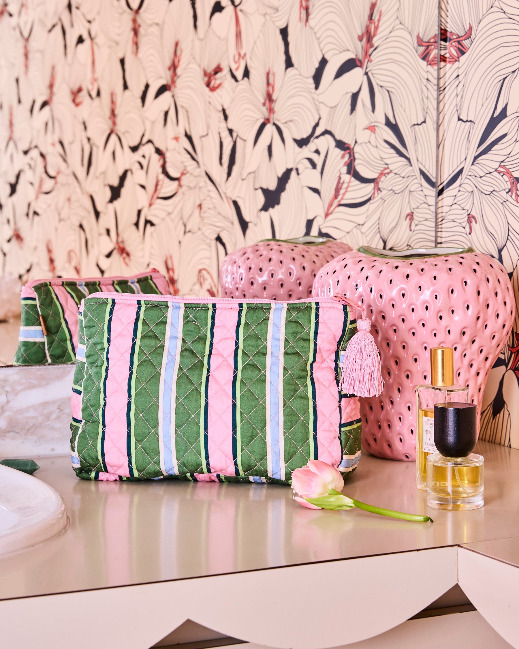 Cactus Stripe Quilted Cotton Toiletry Purse styled on vanity with pink striped cosmetic bag and beauty products