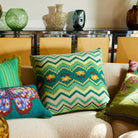 Calina Knit Cushion in Verdant green with zigzag chevron pattern and floral motifs on living room sofa