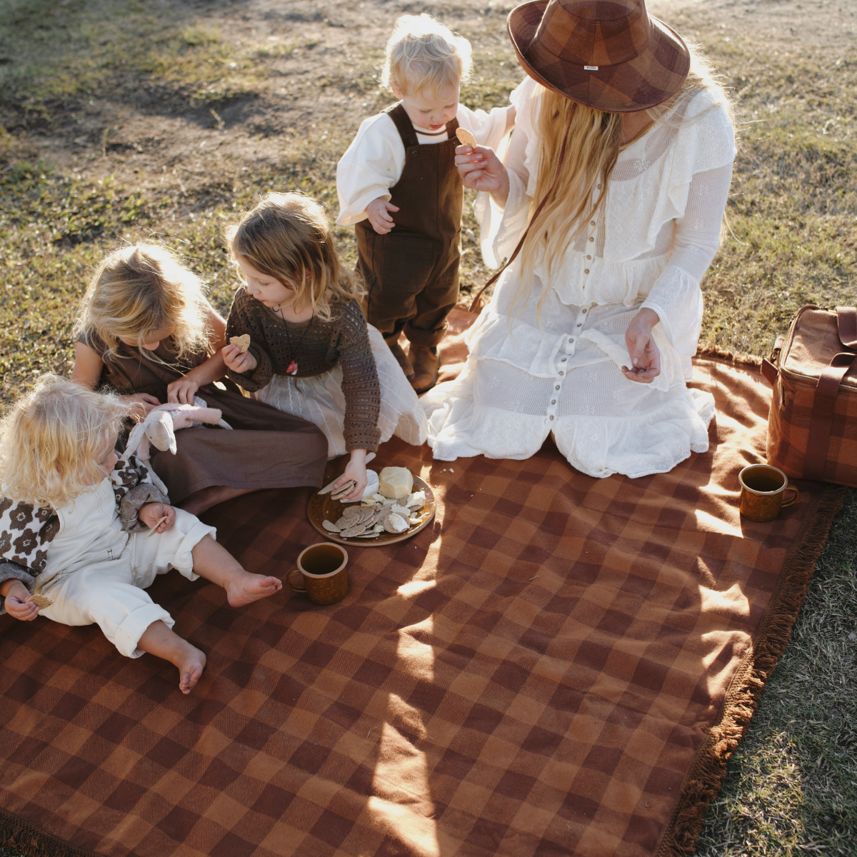Family picnic scene on Camp Picnic Rug by Wandering Folk showing outdoor durability and comfort