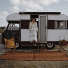 Woman standing on Camp Picnic Rug by Wandering Folk at vintage caravan showing 164cm x 147cm size