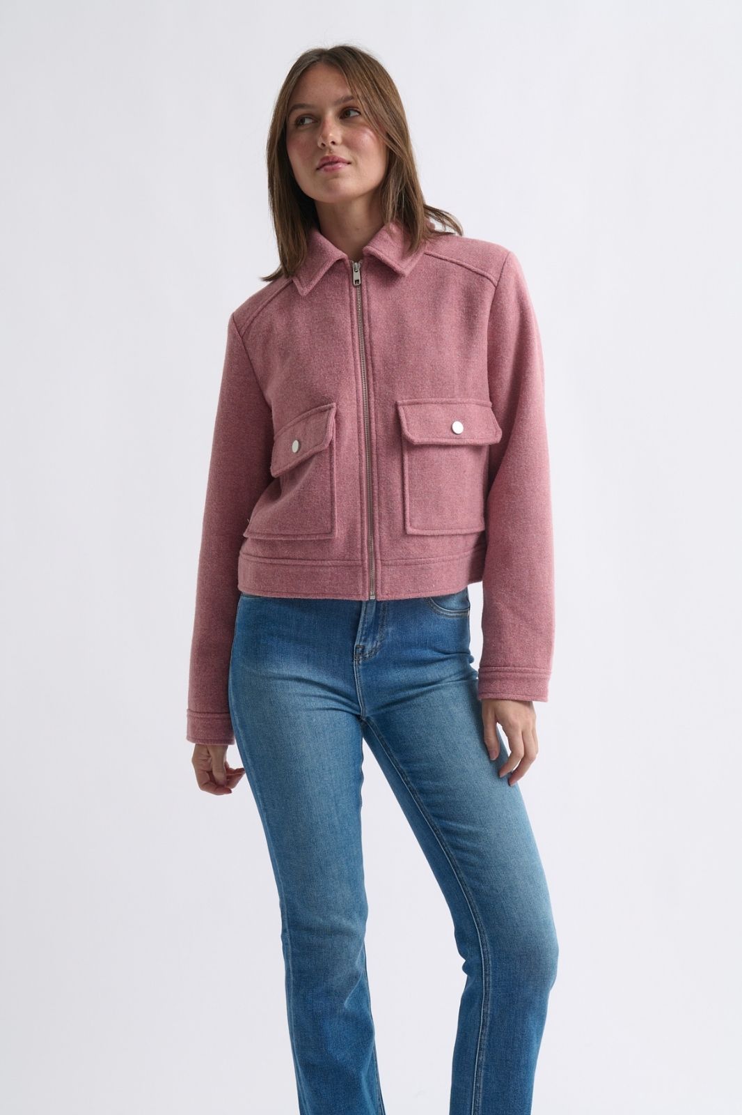 Lifestyle shot woman styling musk pink Carla Jacket with jeans