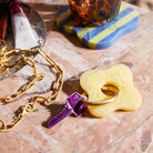 Pink marble resin flower-shaped keyring with gold carabiner ring on white background